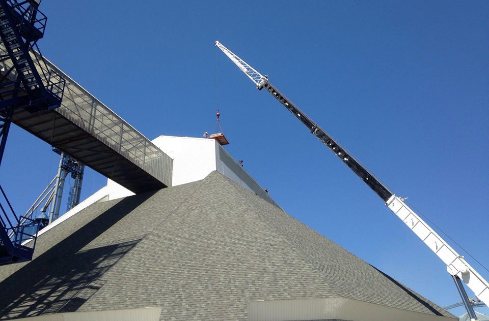 Crane lifting materials for steel building construction on a large project.