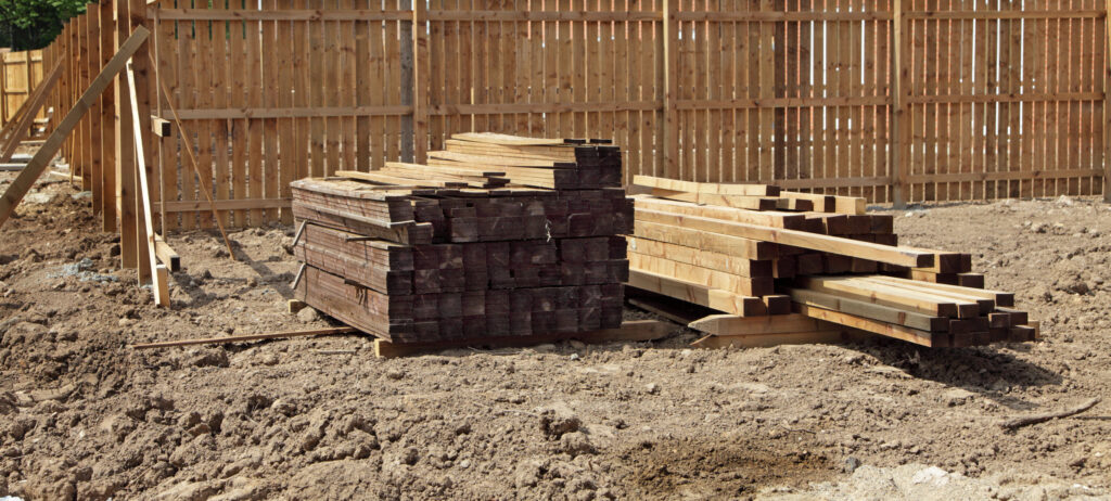 Wood planks stacked for framing at a building construction site