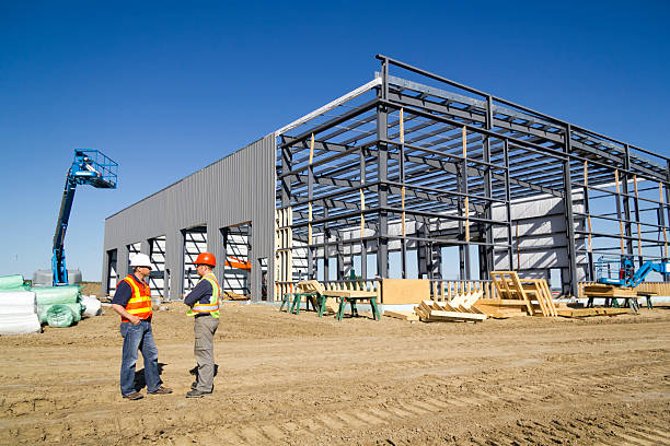 Construction workers discussing steel building framework