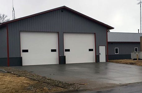 Well-maintained hybrid steel building with durable exterior and garage doors