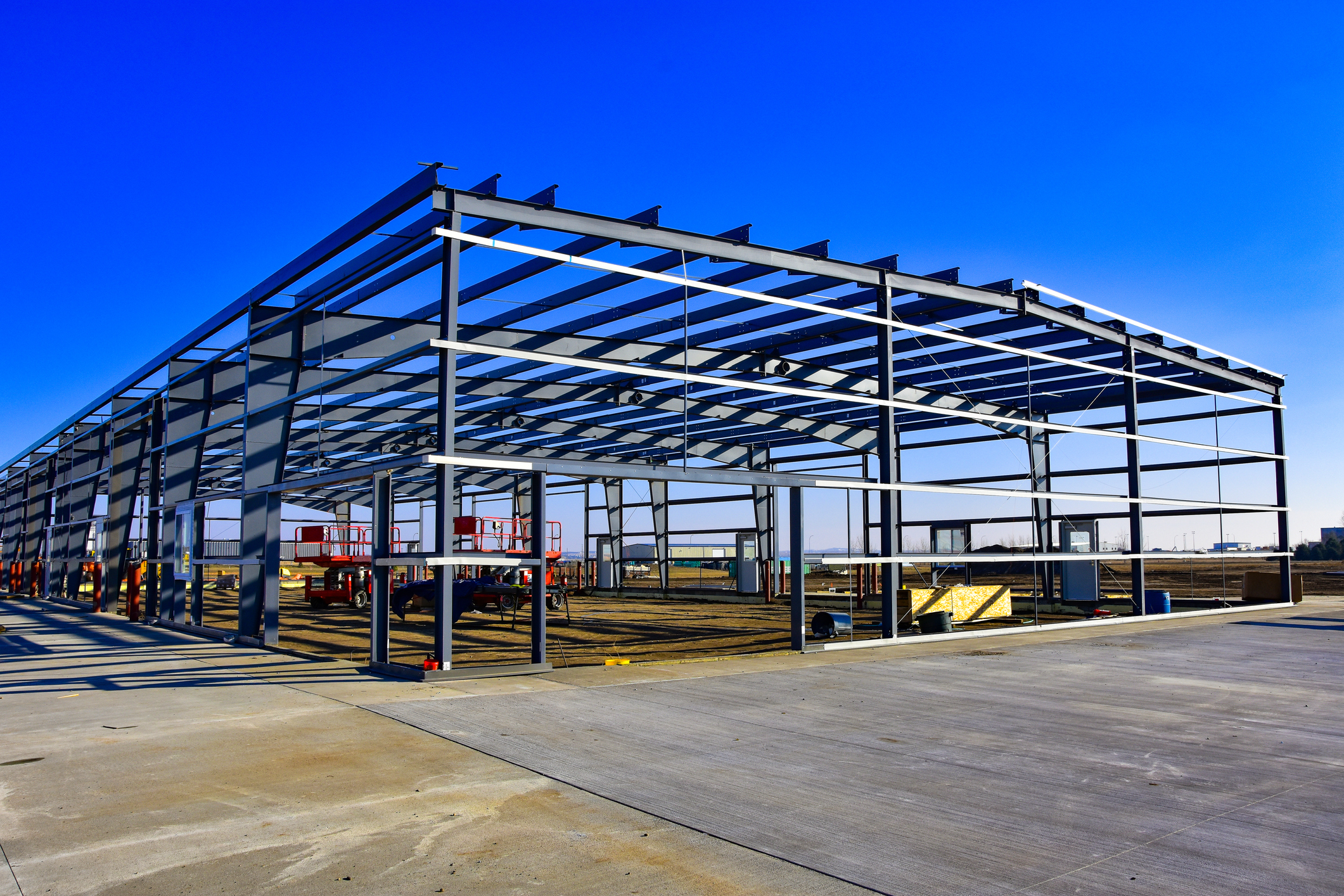 Pre-engineered steel building framework under construction, offering durability